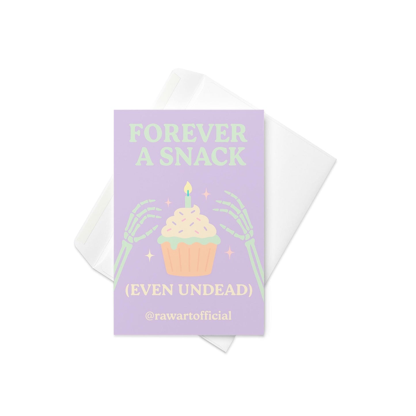 Halloween card with skeleton hands holding cupcake and text “Forever a Snack (Even Undead)” in pastel purple and green.