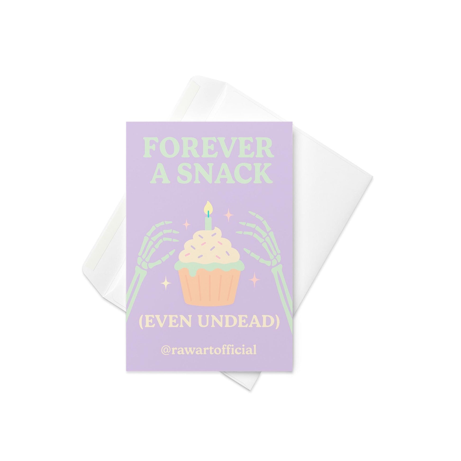 Halloween card with skeleton hands holding cupcake and text “Forever a Snack (Even Undead)” in pastel purple and green.