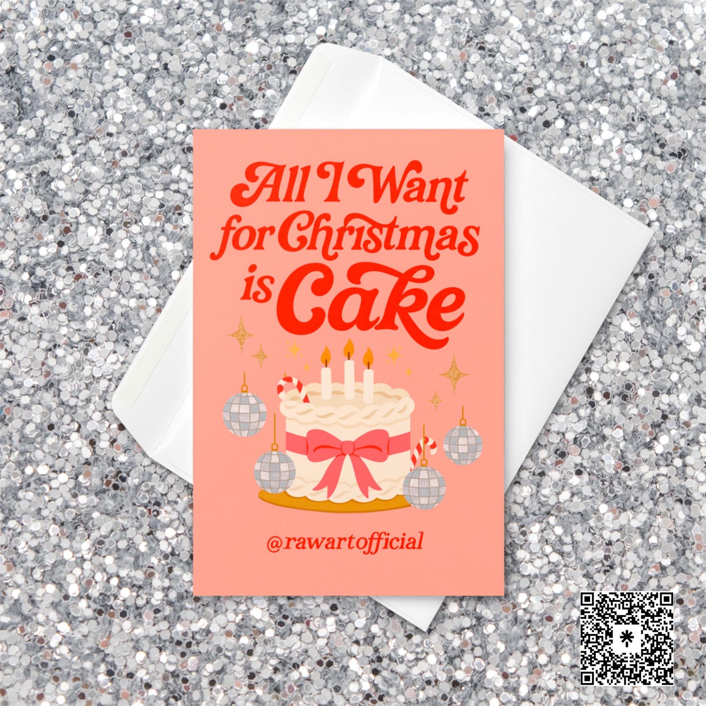 Retro pink Christmas card with the phrase “All I Want for Christmas Is Cake,” featuring a frosted white cake with a pink bow, candy canes, and disco ball ornaments on a coral background.