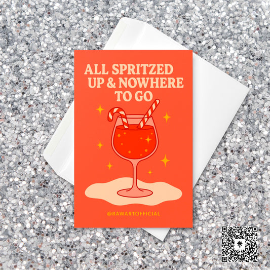 Retro orange Christmas card featuring a glass of spritz with two candy cane straws and sparkly golden stars, with the phrase “All Spritzed Up & Nowhere to Go” in cream-colored text.