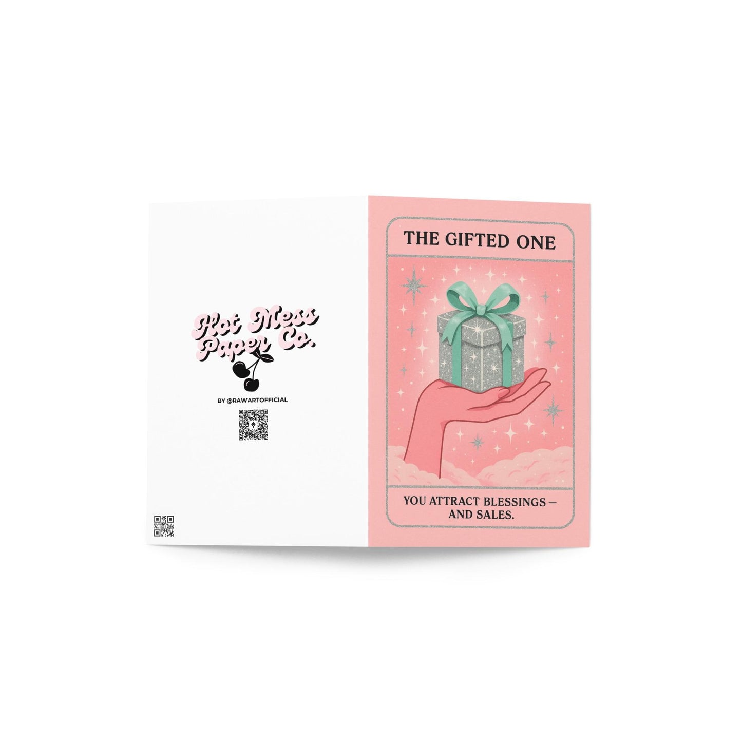 Pastel pink and mint Christmas tarot-style card featuring a sparkling silver gift box with a green bow resting on an illustrated hand, with the text “The Gifted One – You attract blessings and sales.”