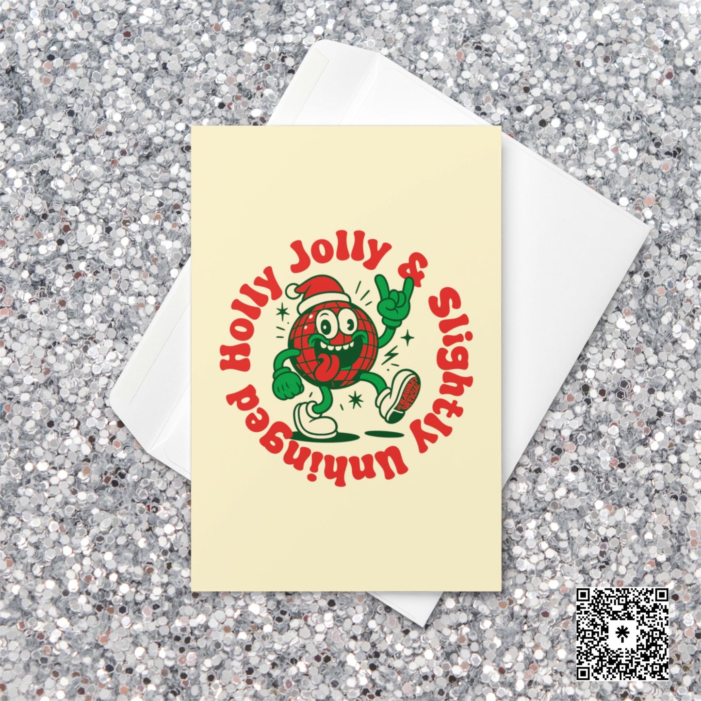 Cream-colored Christmas card featuring a plaid ornament character in a Santa hat with text reading “Holly Jolly & Slightly Unhinged.”