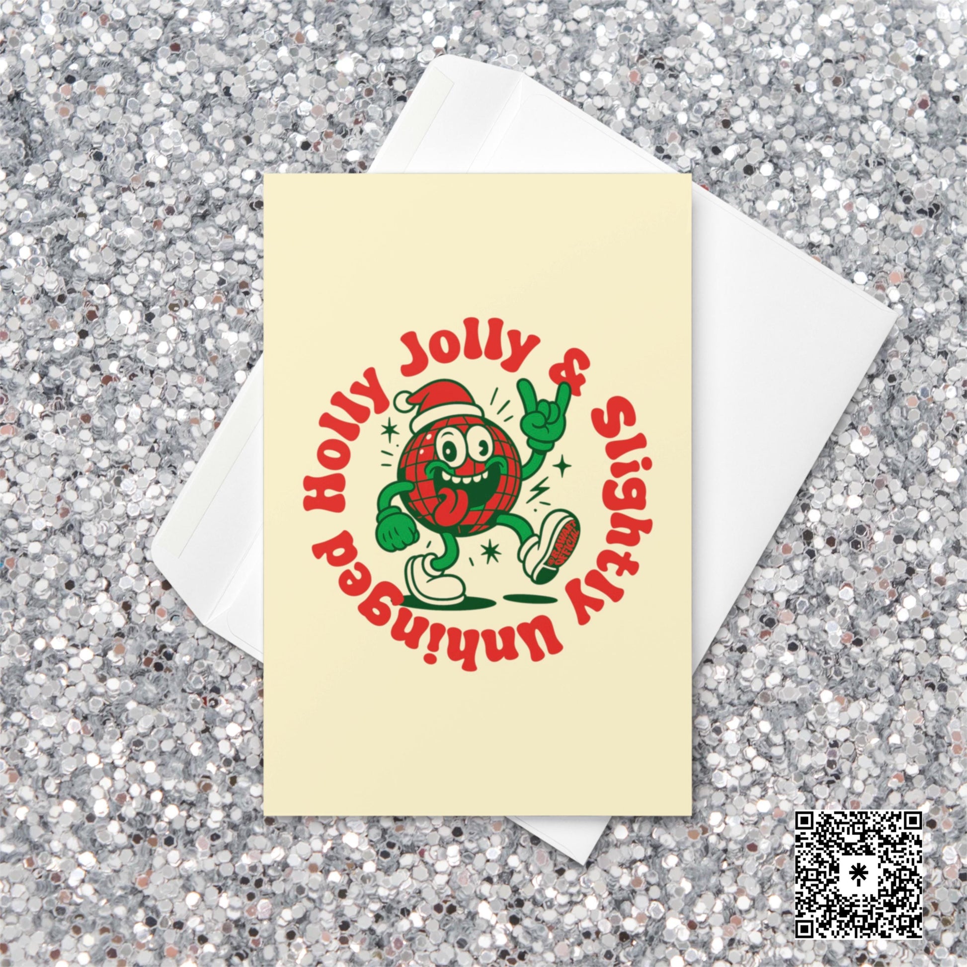 Cream-colored Christmas card featuring a plaid ornament character in a Santa hat with text reading “Holly Jolly & Slightly Unhinged.”