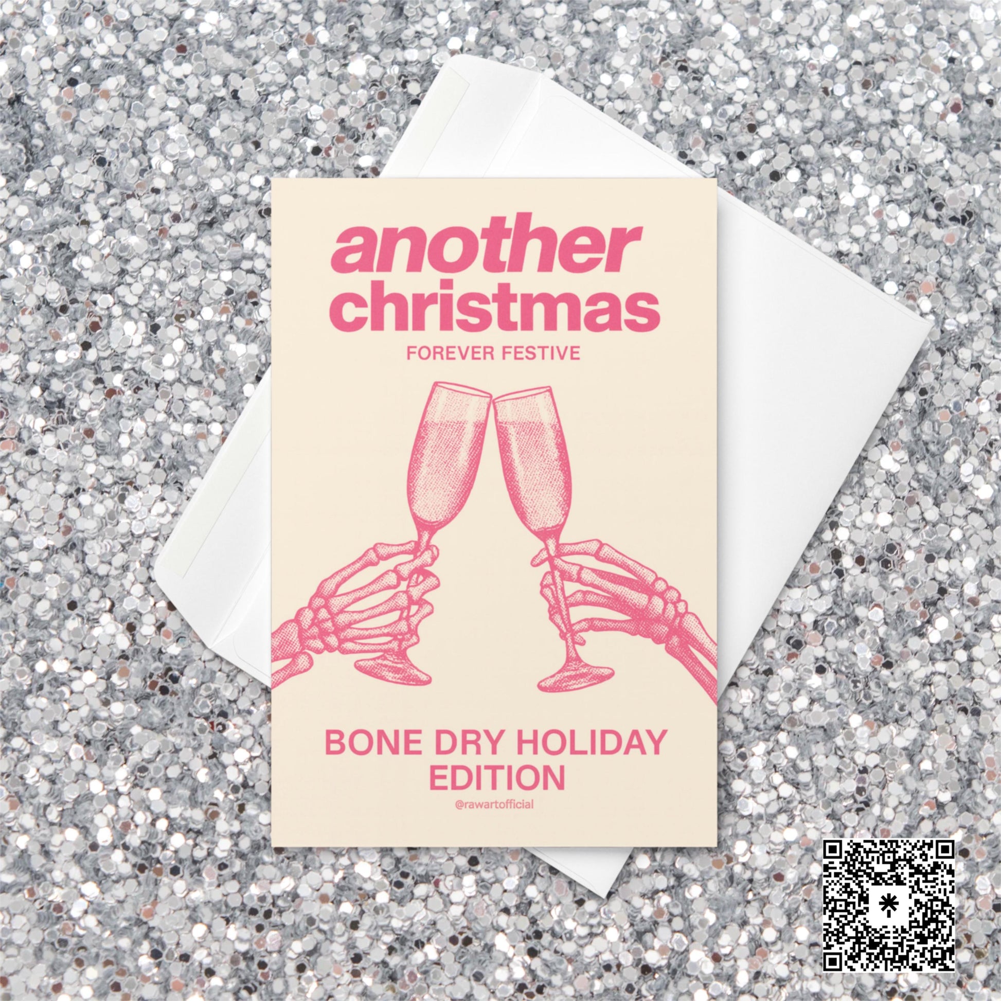 Minimalist Christmas card with pink text reading “Another Christmas — Bone Dry Holiday Edition” above two skeleton hands clinking champagne glasses.