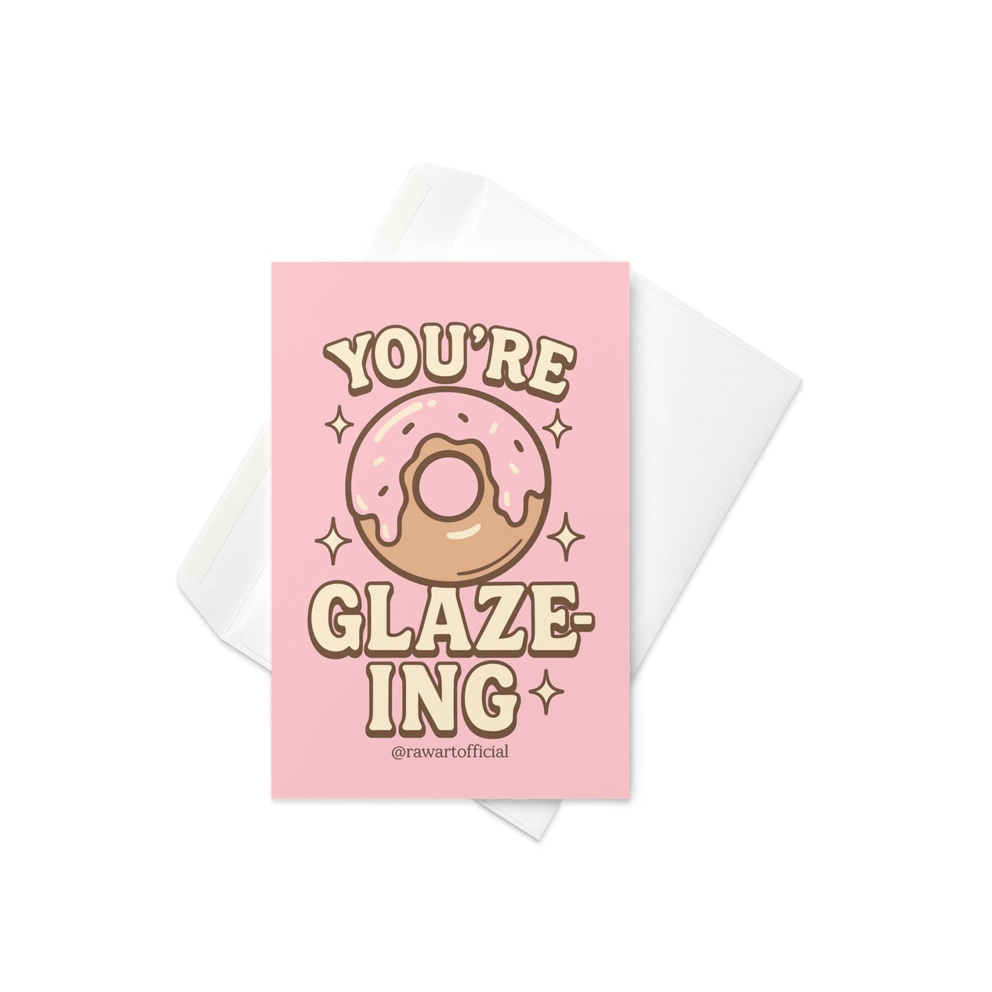 Pink donut with icing surrounded by sparkles and text reading “You’re Glaze-ing,” designed by @rawartofficial.