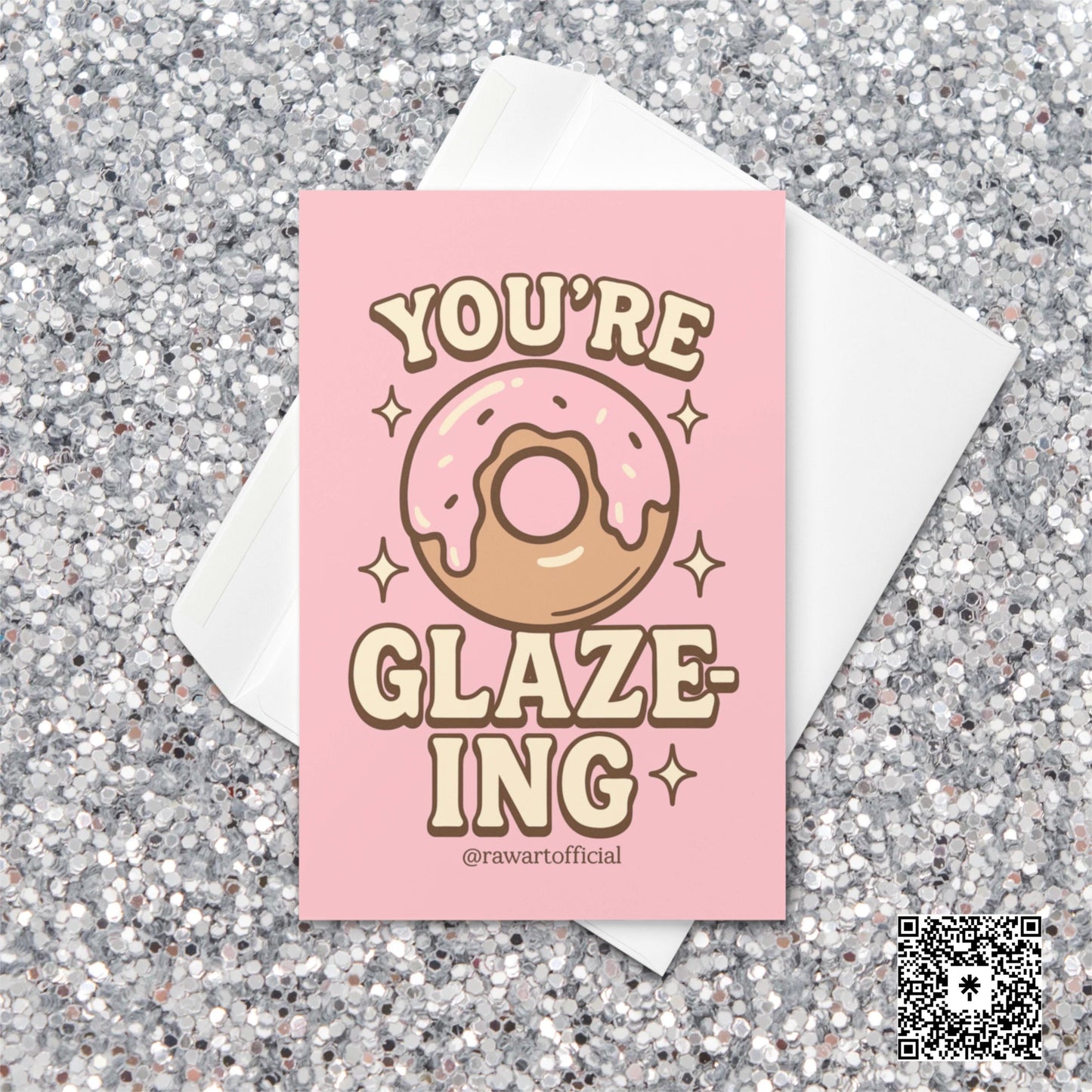 Pink donut with icing surrounded by sparkles and text reading “You’re Glaze-ing,” designed by @rawartofficial.