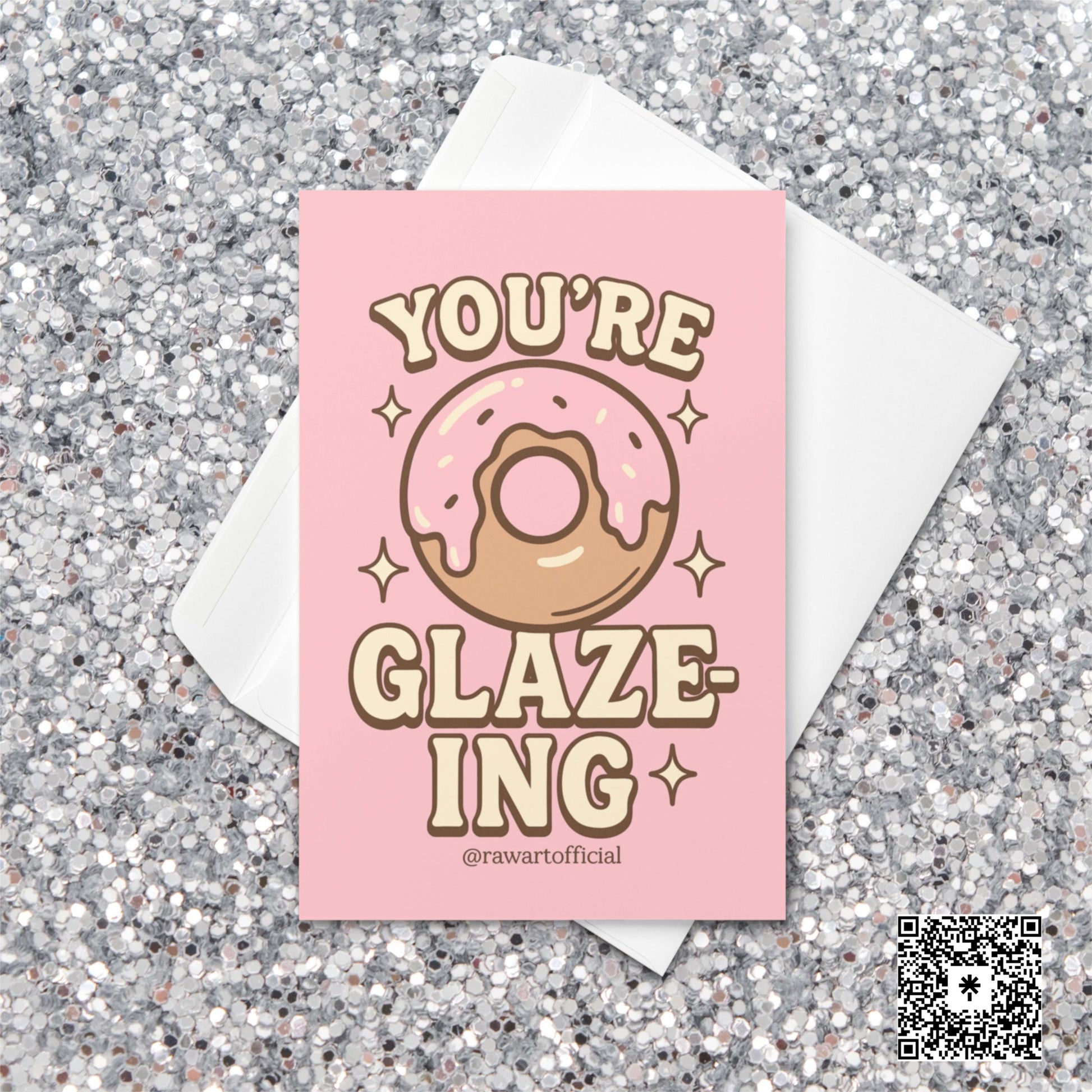 Pink donut with icing surrounded by sparkles and text reading “You’re Glaze-ing,” designed by @rawartofficial.