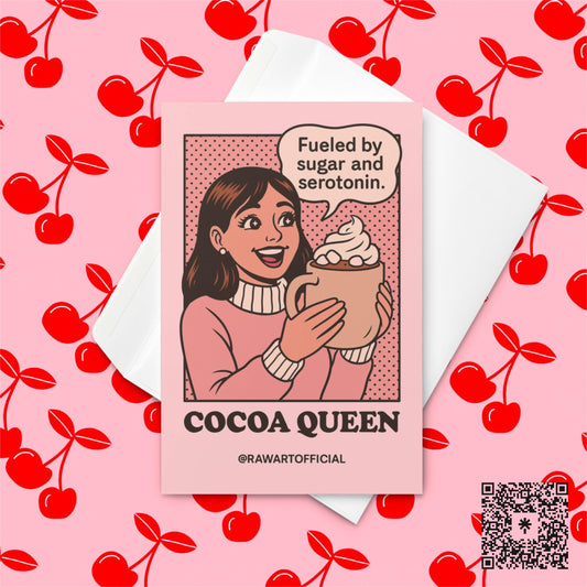 Smiling woman in pink sweater holding large mug of cocoa with whipped cream, speech bubble says “Fueled by sugar and serotonin,” text below reads “Cocoa Queen,” designed by @rawartofficial.