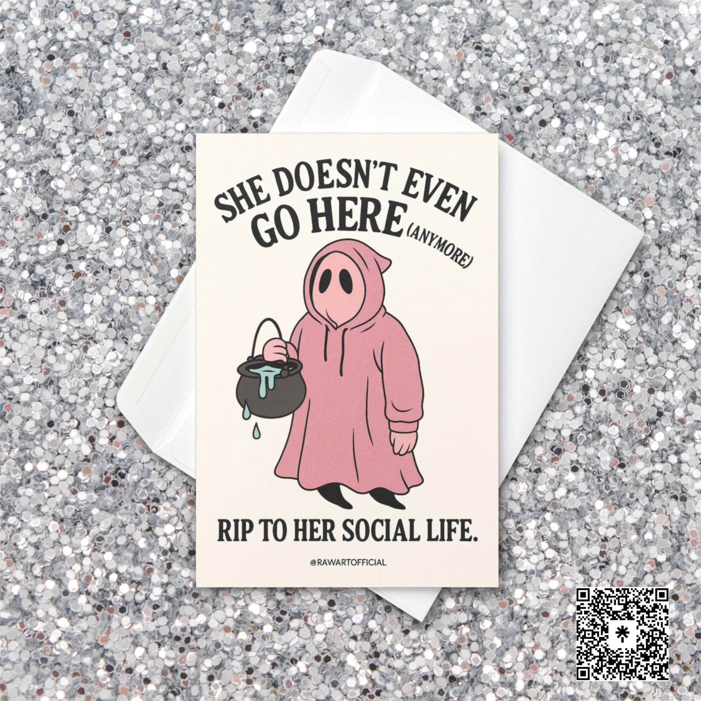 Pink ghost in a hoodie holding a cauldron with text “She Doesn’t Even Go Here (Anymore)” – funny Mean Girls inspired Halloween card.