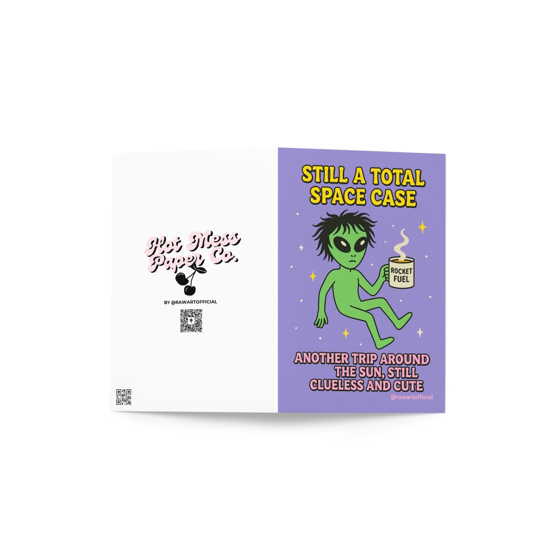 Green alien holding a coffee mug labeled “Rocket Fuel” floating in space with text “Still a Total Space Case.”