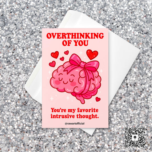 Cute pink Valentine card with a cartoon brain tied in a bow surrounded by hearts, captioned “Overthinking of You – You’re my favorite intrusive thought.”