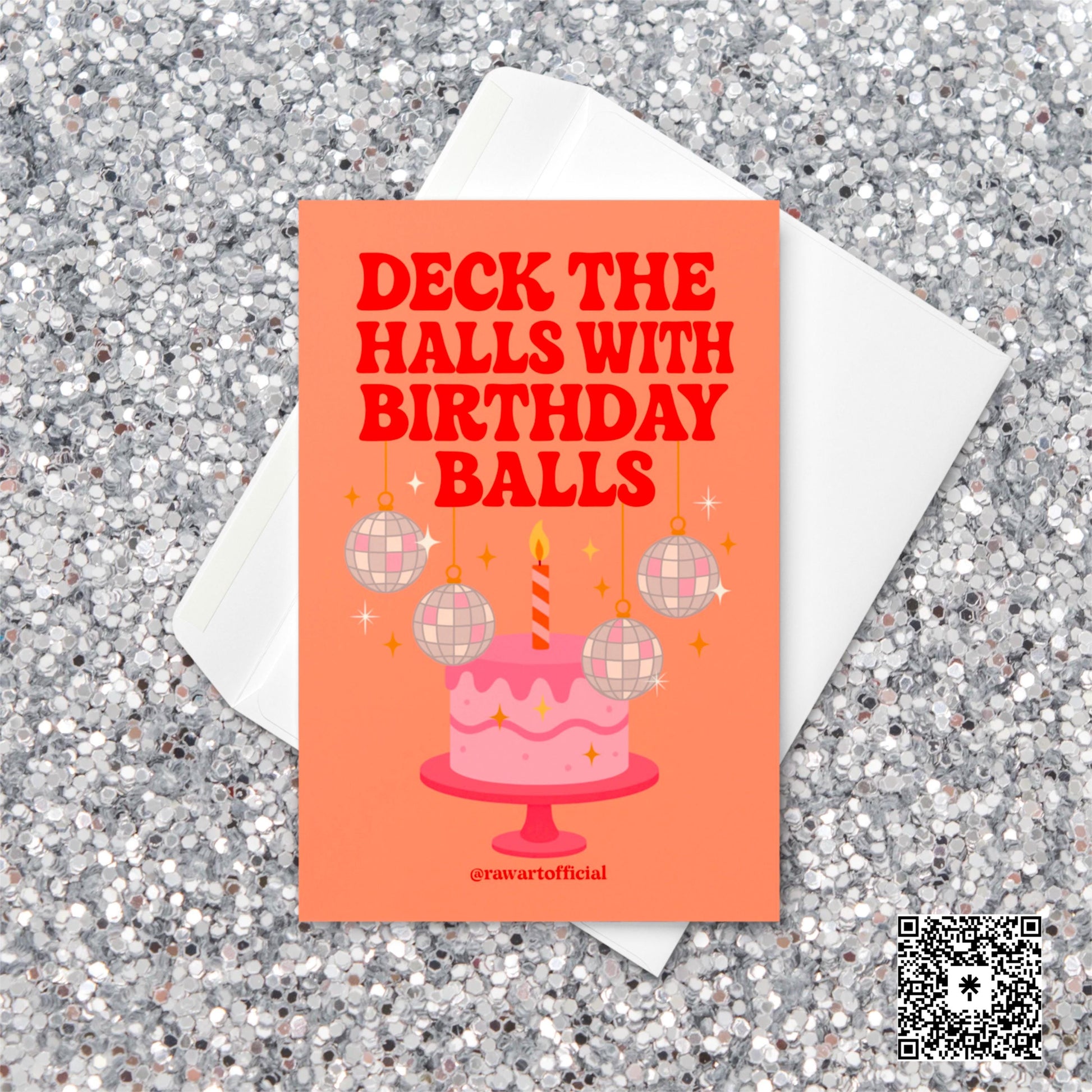Retro holiday birthday card featuring a pink cake with a striped candle and hanging disco ball ornaments. Text reads “Deck the Halls with Birthday Balls” in bold red letters on an orange background.