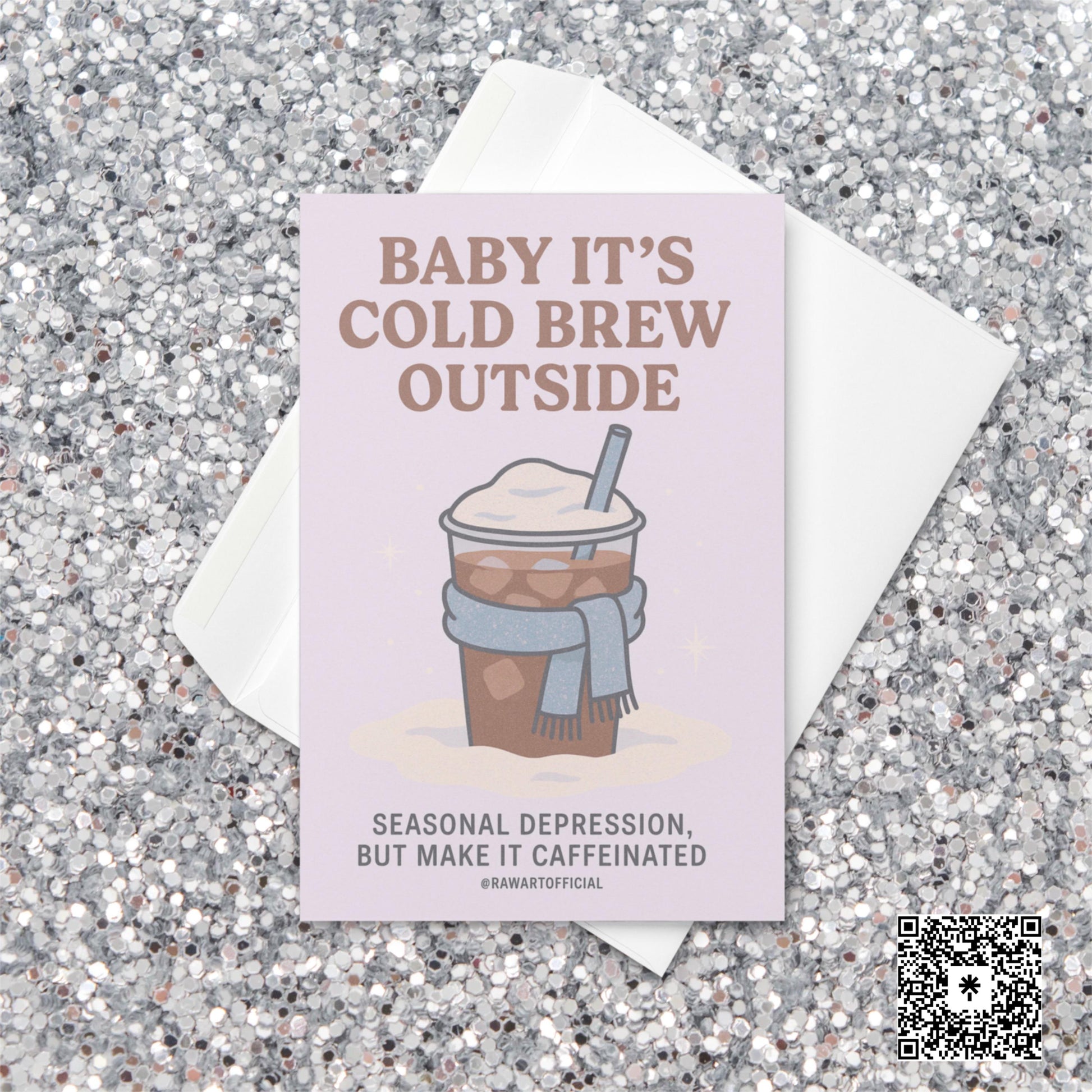 Pastel holiday card featuring an iced coffee in a scarf with text reading “Baby It’s Cold Brew Outside — Seasonal depression, but make it caffeinated.”