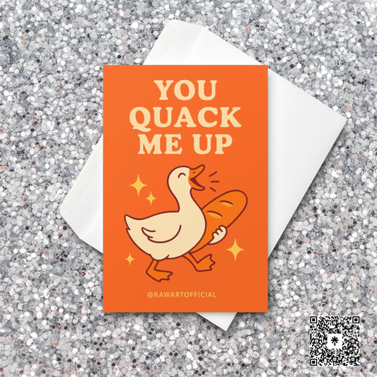 Cute goose holding a loaf of bread with sparkles and text reading “You Quack Me Up” on an orange background.