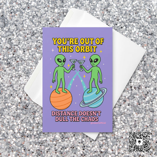 Two cartoon aliens clinking martini glasses while standing on planets with text “You’re out of this orbit — distance doesn’t dull the chaos.”