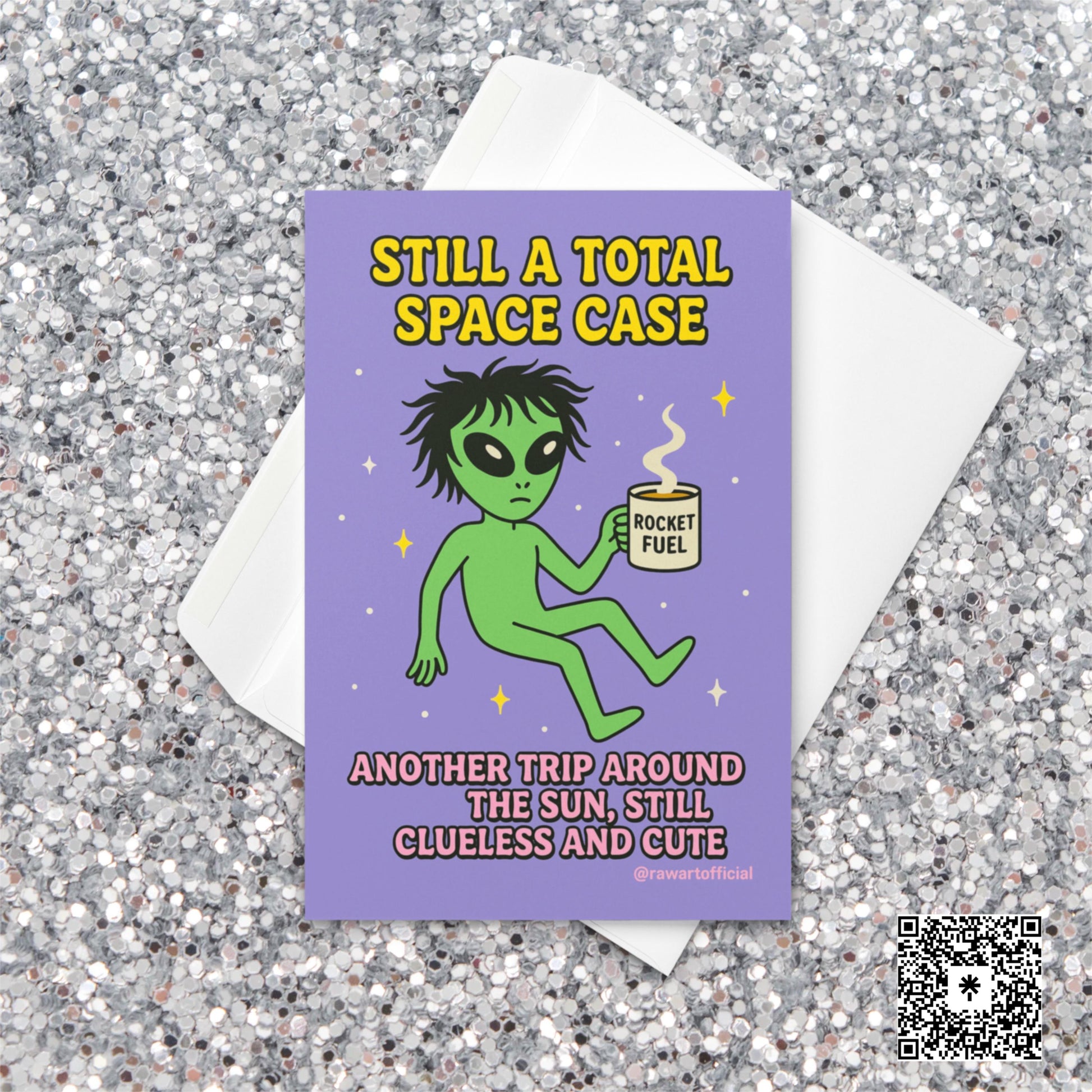 Green alien holding a coffee mug labeled “Rocket Fuel” floating in space with text “Still a Total Space Case.”
