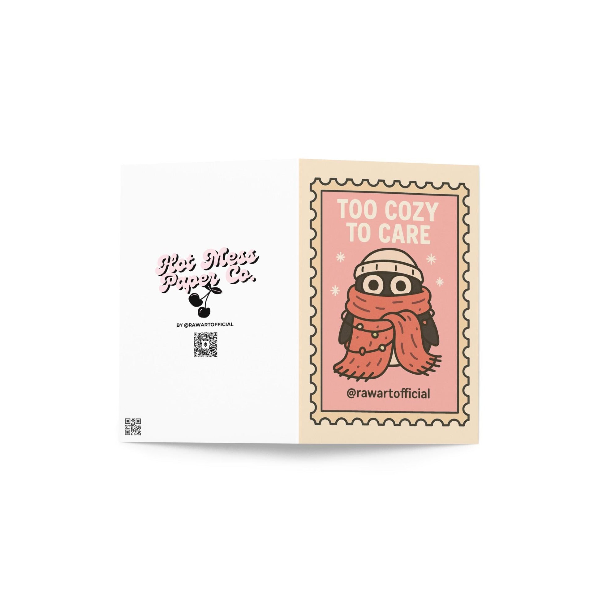 Stamp-style pink holiday card with bundled penguin wearing scarf and beanie, caption reads “Too Cozy To Care.”