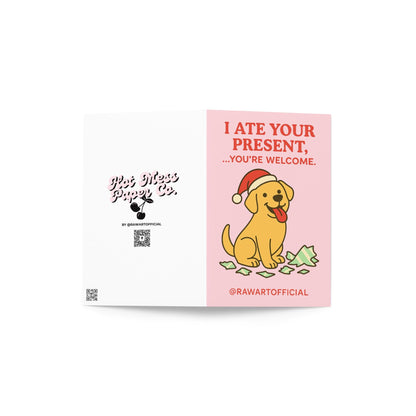 Funny Christmas card featuring a Labrador dog in a Santa hat sitting beside torn wrapping paper with text “I ate your present you’re welcome”