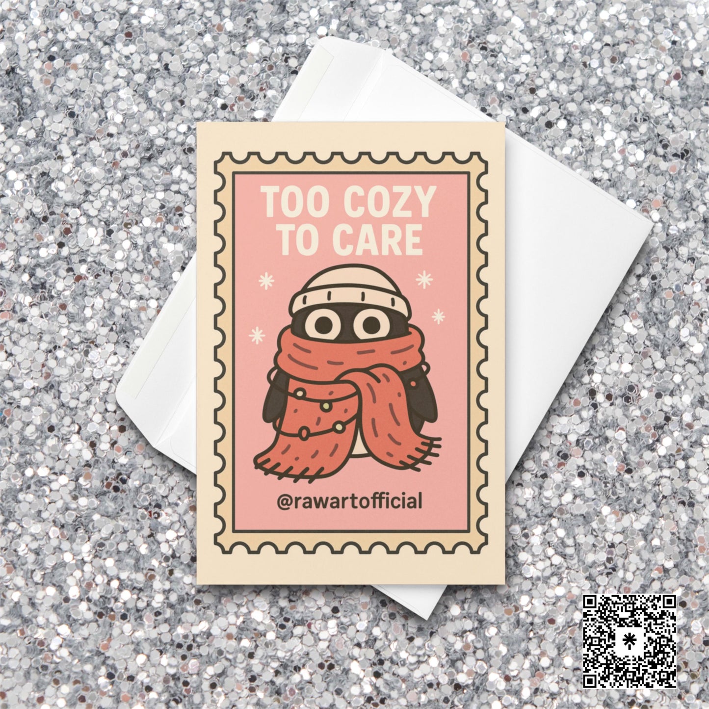 Stamp-style pink holiday card with bundled penguin wearing scarf and beanie, caption reads “Too Cozy To Care.”