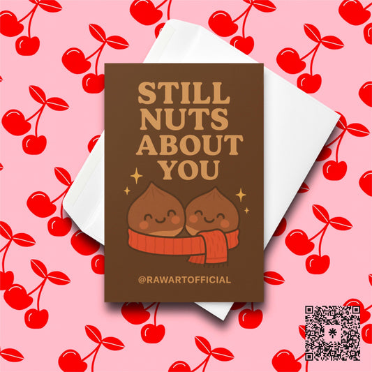 Cute chestnut couple wrapped in a scarf with text “Still Nuts About You.”