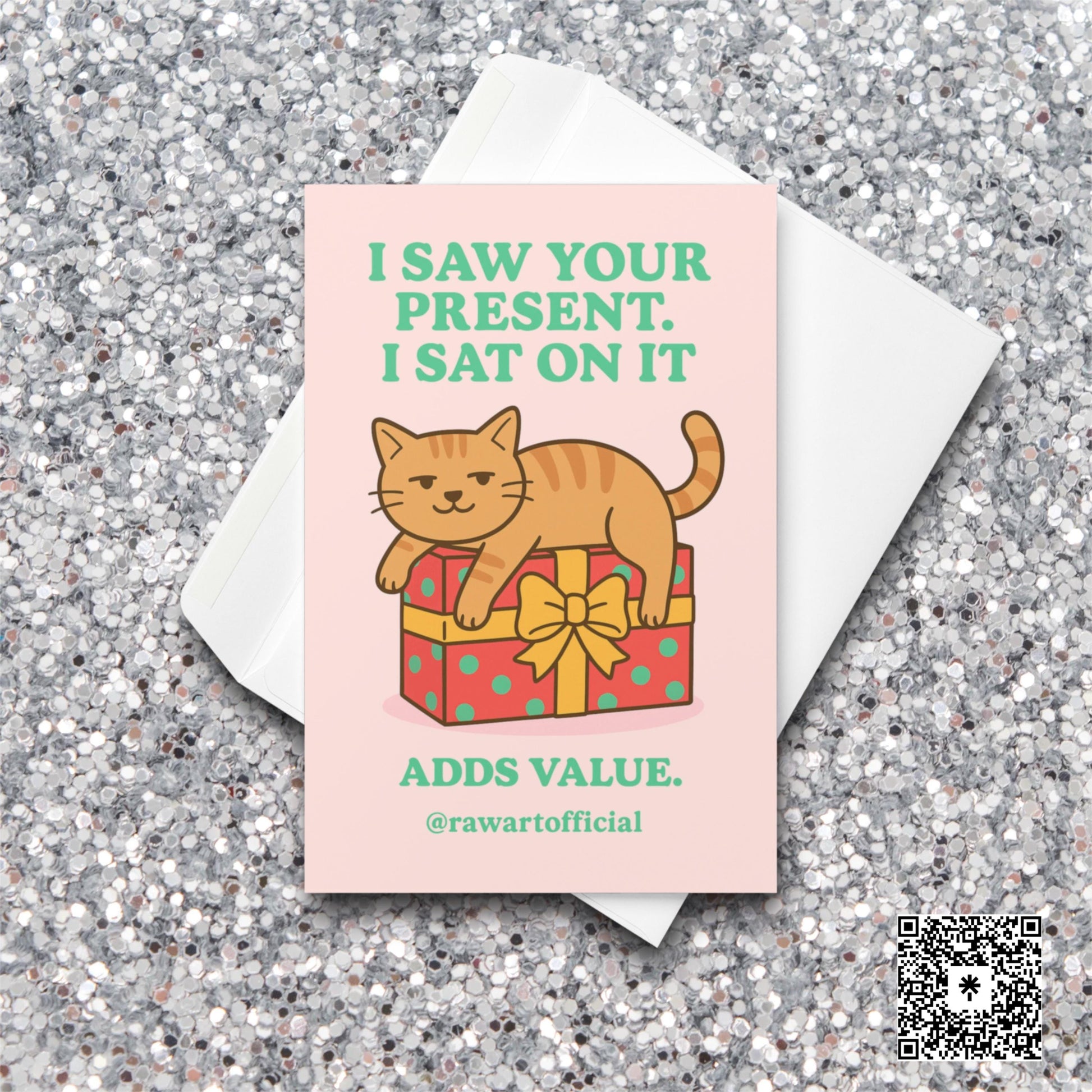 Orange cat sitting on a wrapped present with text “I Saw Your Present. I Sat On It.”