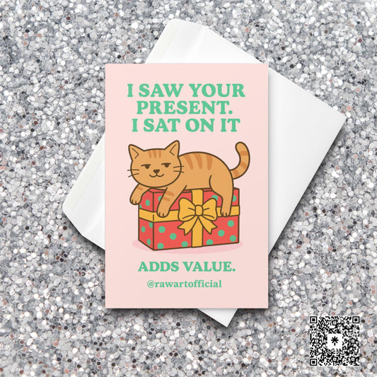 Orange cat sitting on a wrapped present with text “I Saw Your Present. I Sat On It.”