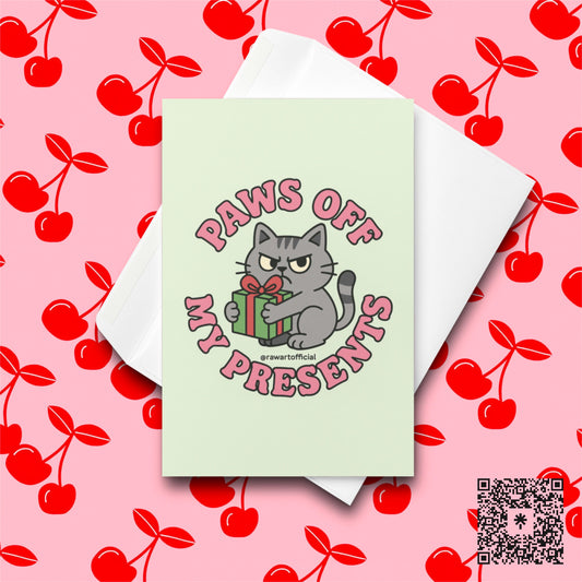 Orange cat in Santa hat ripping wrapping paper with text “Naughty By Nature.”