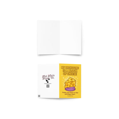 Sparkly cartoon cheese wedge on yellow background with text “My Birthstone Is a Block of Cheese.”
