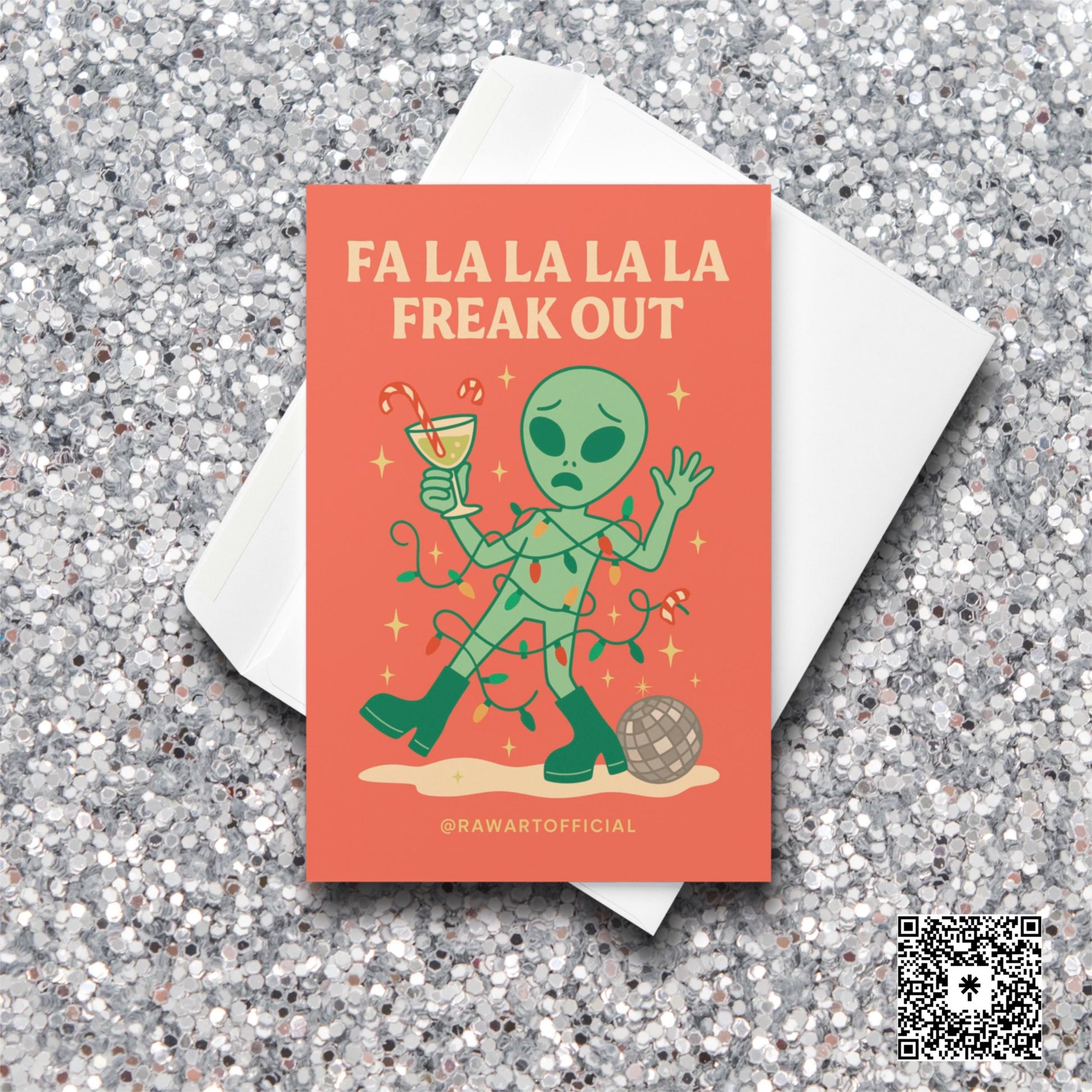 Alien tangled in Christmas lights holding a drink with text “Fa La La La La Freak Out.”