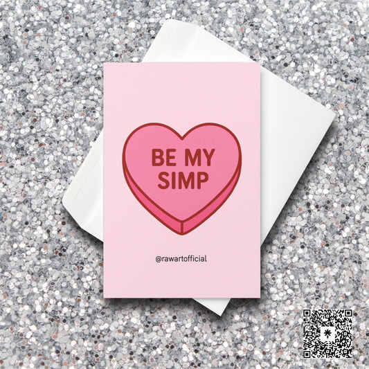Pink candy heart card with the phrase “Be My Simp” in red text on a soft pink background.