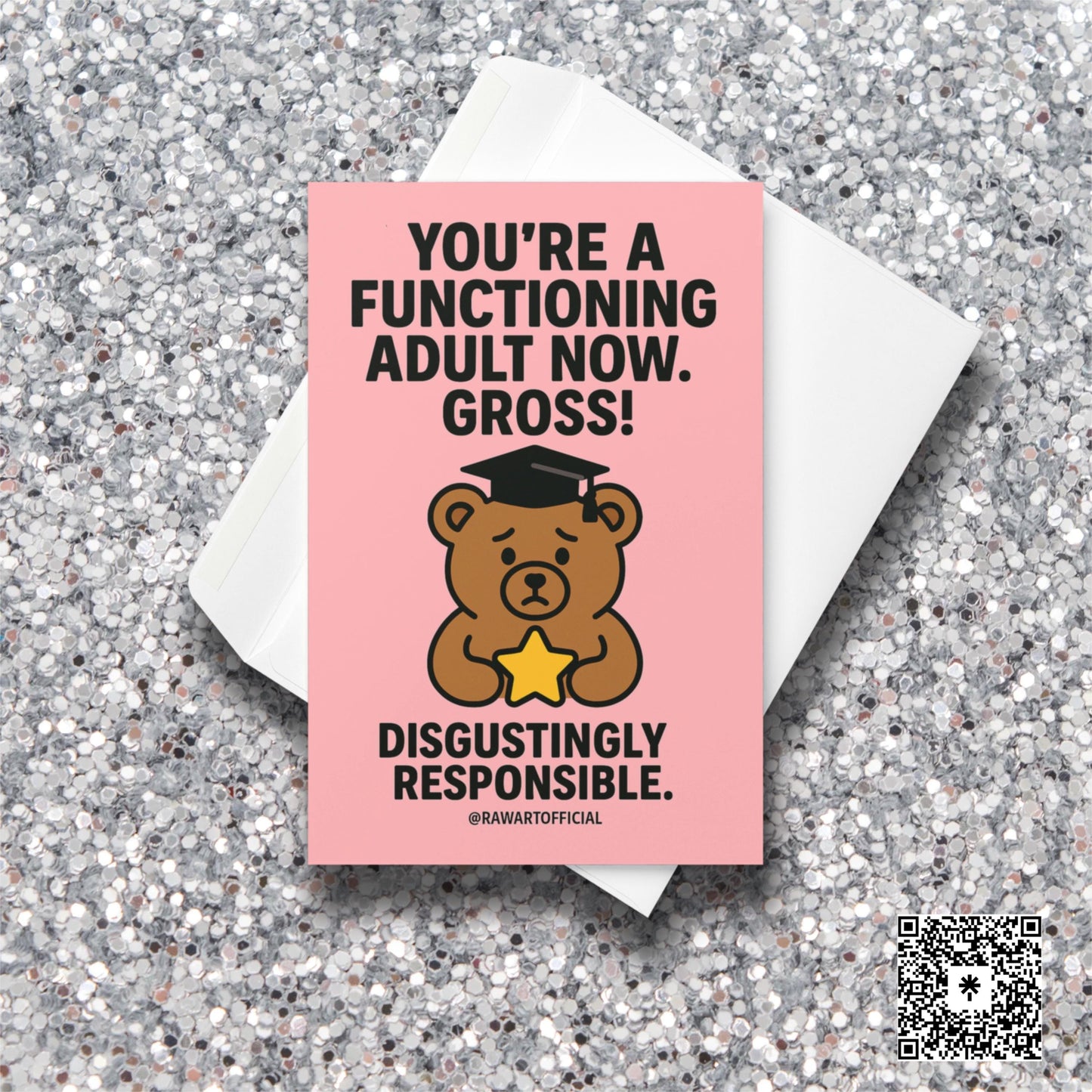 Pink graduation card with sad bear in cap holding a star and bold text saying “You’re a functioning adult now. Gross.”