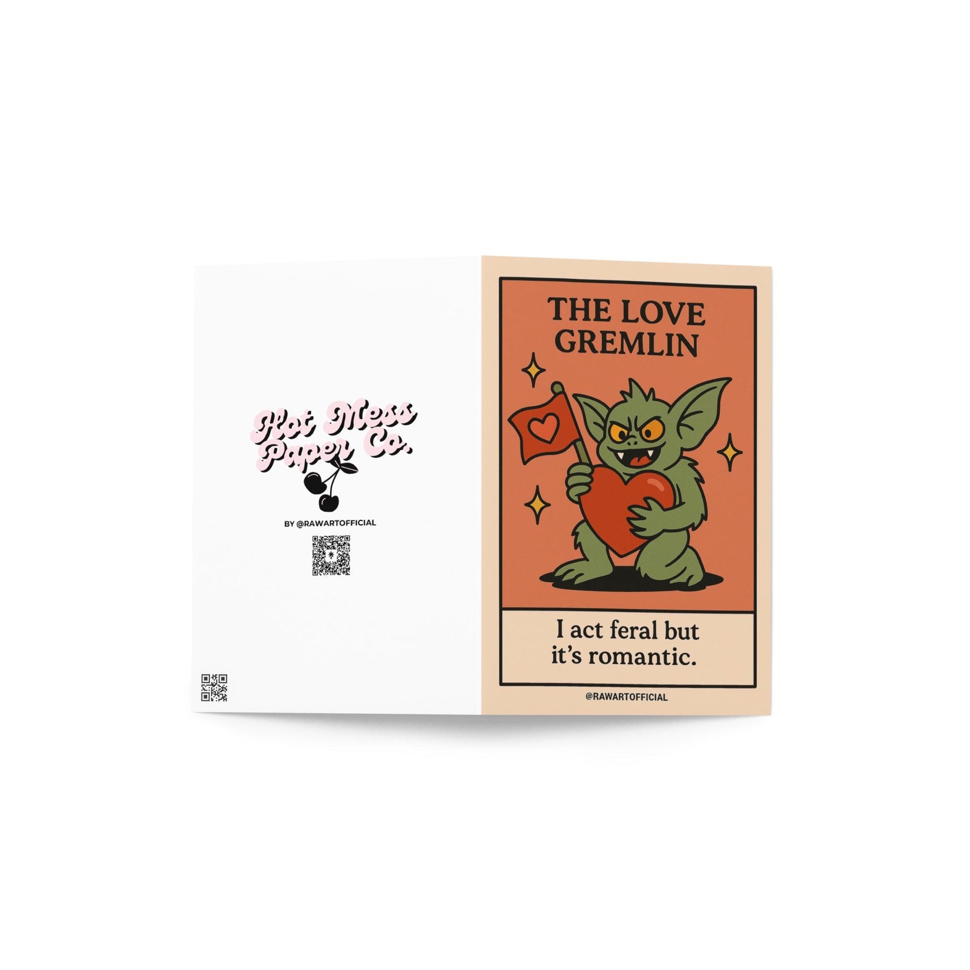 Green gremlin holding a big red heart and love flag with the phrase “I act feral but it’s romantic.”