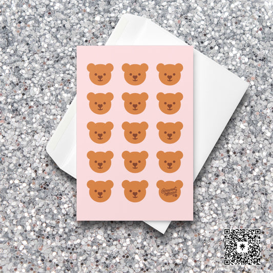 Pink card with repeating kawaii teddy bear faces in rows, one signed @rawartofficial.