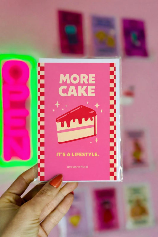 Bright pink birthday card featuring a glossy red cake slice with sparkles and the phrase “More Cake It’s a Lifestyle.”