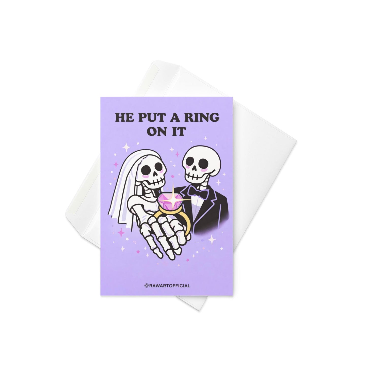 Lavender wedding card featuring skeleton bride and groom holding a large pink gemstone ring with text “He Put a Ring On It.”