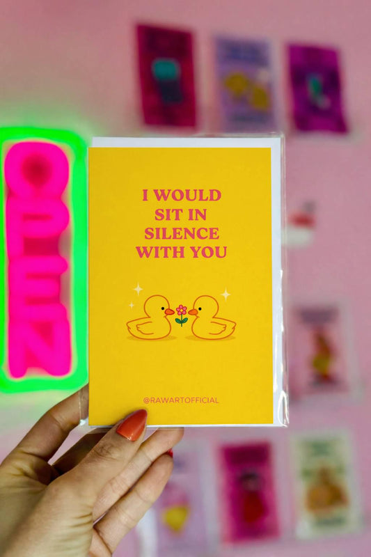 Cute romantic card featuring two small ducks with a flower and text “I would sit in silence with you” on a yellow background