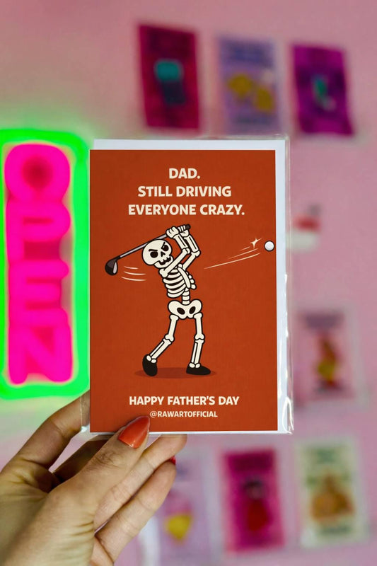 Funny Fathers Day golf dad card with skeleton swinging club and text “Still Driving Everyone Crazy” on orange background