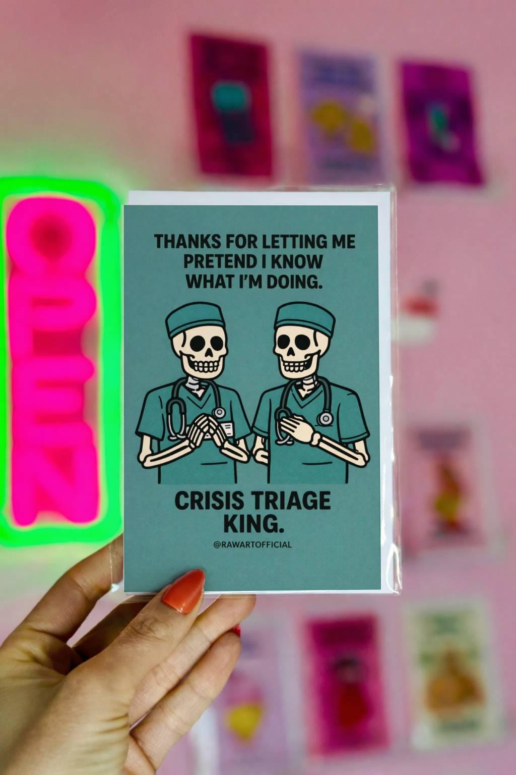 Funny male nurse greeting card with text “Crisis Triage King” on teal background with @rawartofficial signature