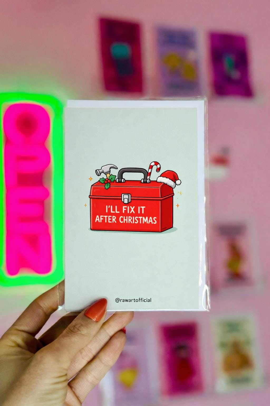 Funny Christmas card for dad with toolbox design reading “I’ll fix it after Christmas” on light blue background