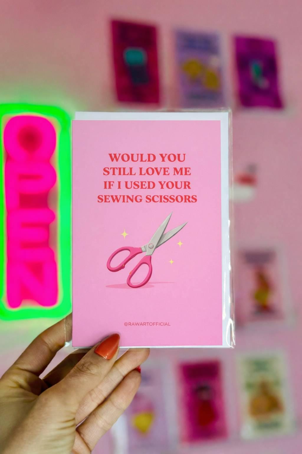 Funny mom greeting card featuring pink sewing scissors with text “Would you still love me if I used your sewing scissors” on a pink background