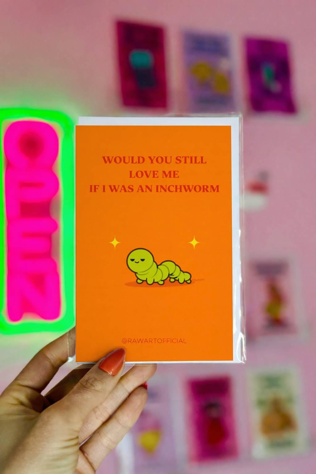 Funny meme greeting card featuring a green inchworm with text “Would you still love me if I was an inchworm” on an orange background
