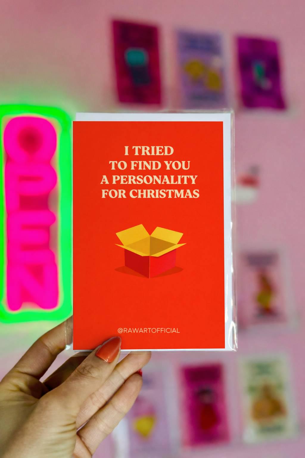 Funny brother Christmas greeting card with text “I tried to find you a personality for Christmas” and open gift box illustration on red background