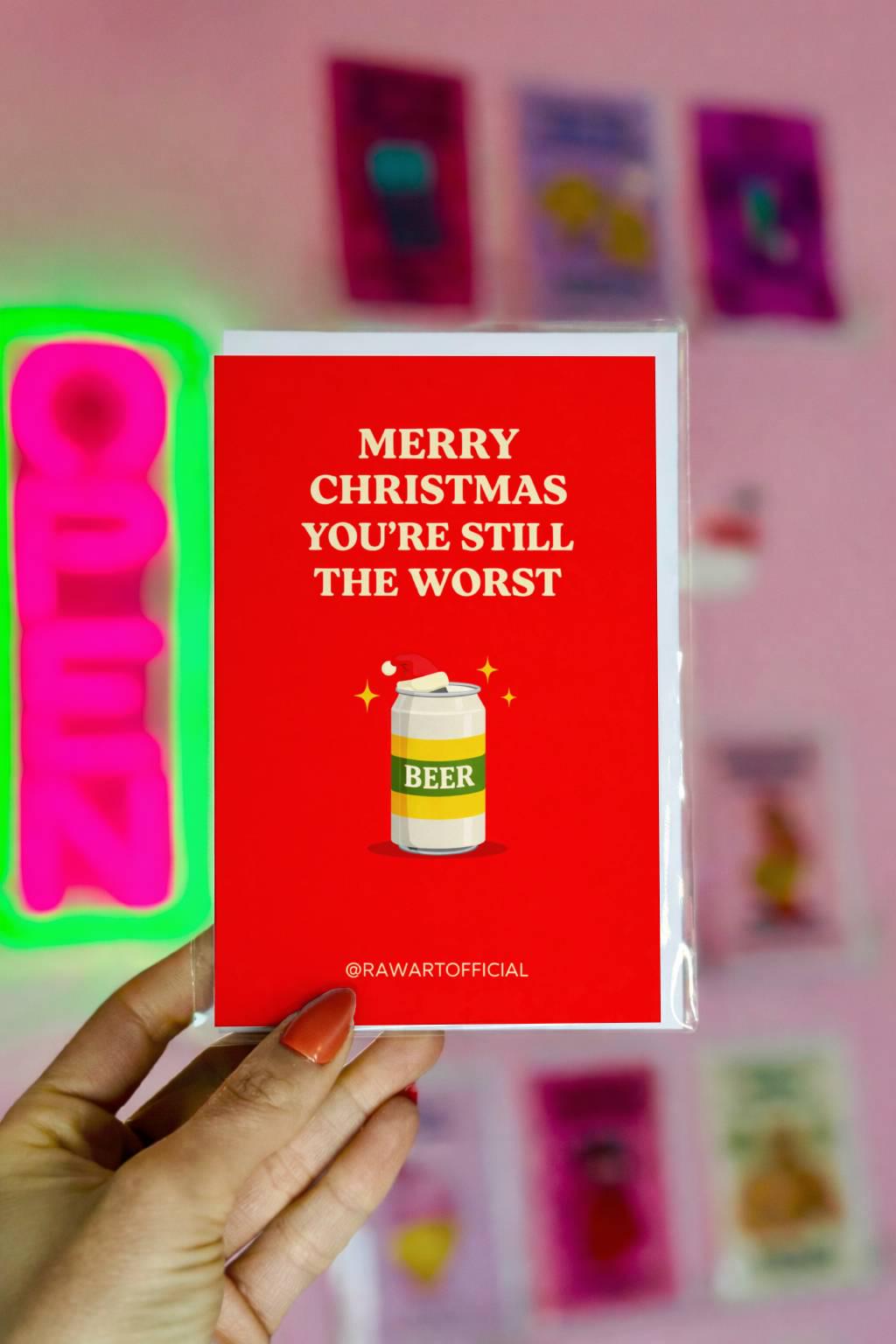 Funny brother Christmas greeting card with text “Merry Christmas you’re still the worst” and beer can illustration on red background