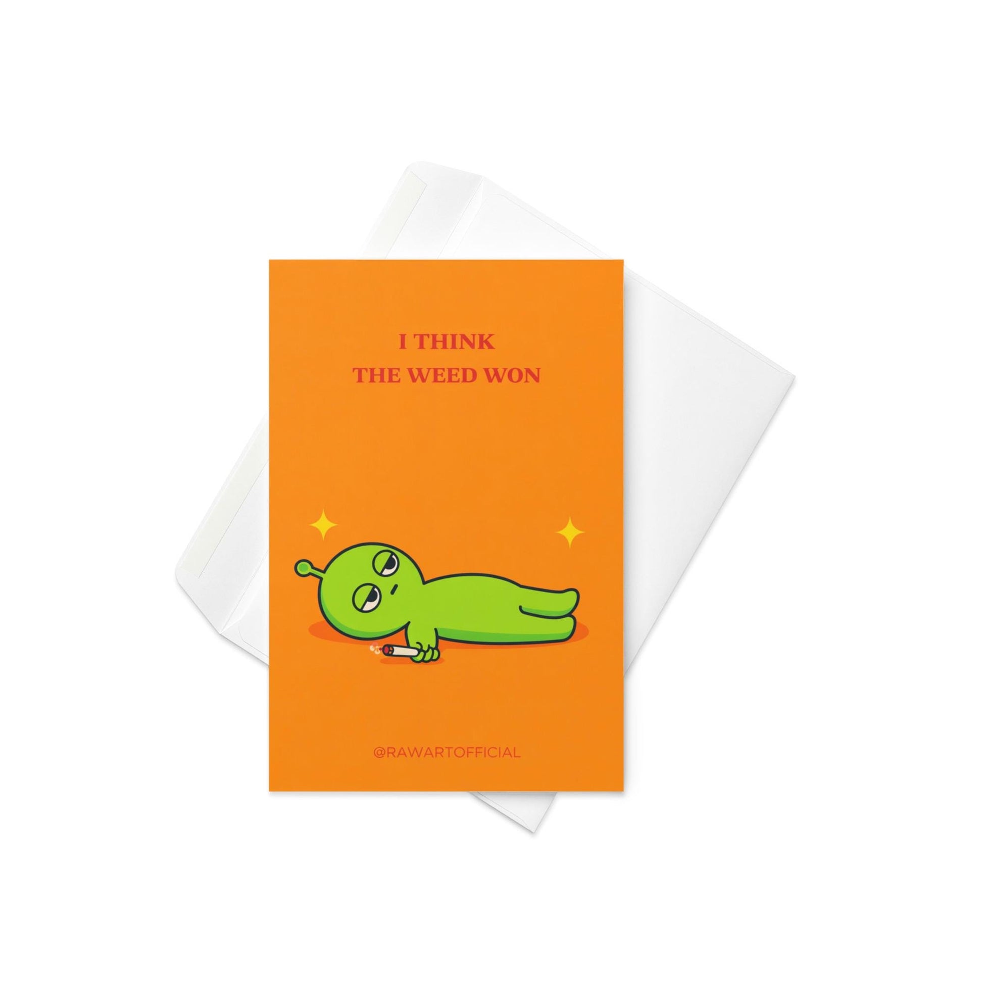 Funny stoner greeting card with green alien lying down holding joint, text says “I think the weed won” on orange background