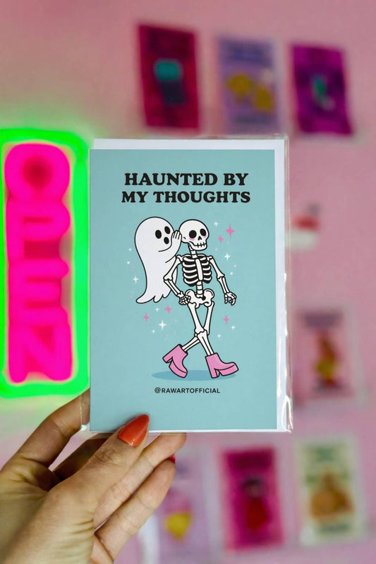 Spooky ghost greeting card with ghost whispering to skeleton and text “Haunted by my thoughts” on blue background