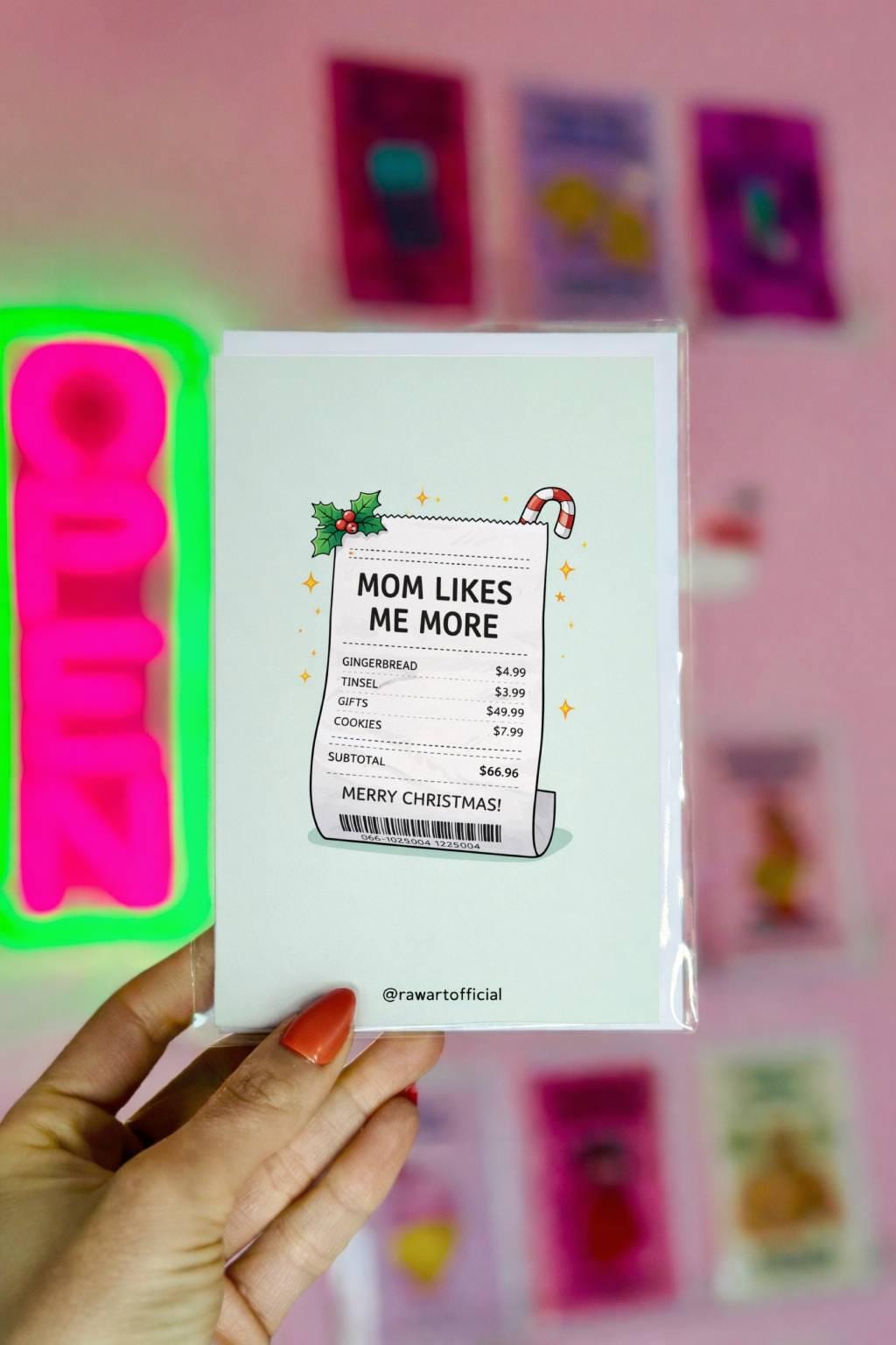 Funny Christmas sibling card with receipt design reading “mom likes me more” on light blue background