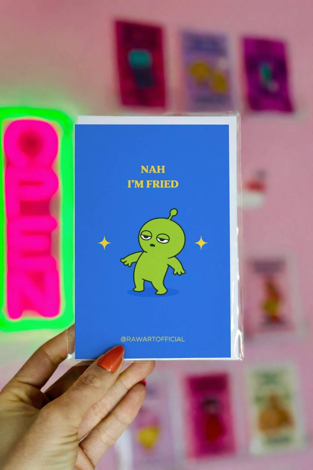 Funny stoner greeting card with green alien standing dazed, text says “Nah I’m fried” on blue background