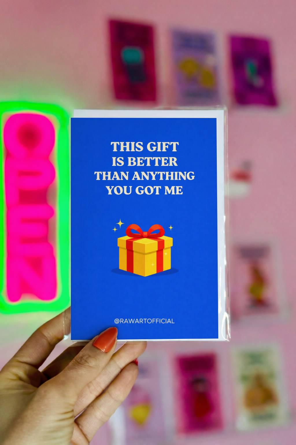 Funny brother Christmas greeting card with text “This gift is better than anything you got me” and present illustration on blue background