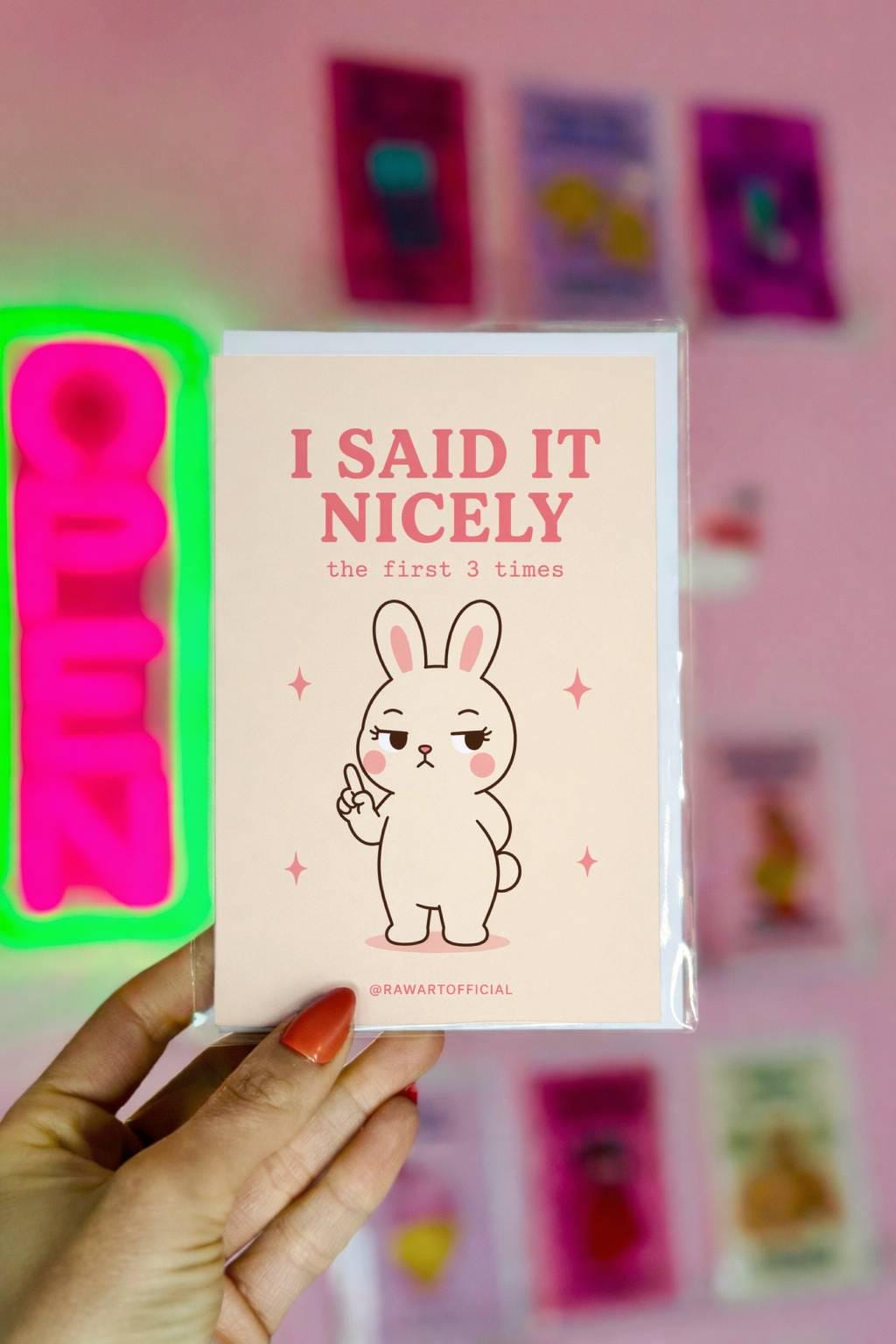 Cute bunny pointing with text “I said it nicely the first 3 times” on a neutral background