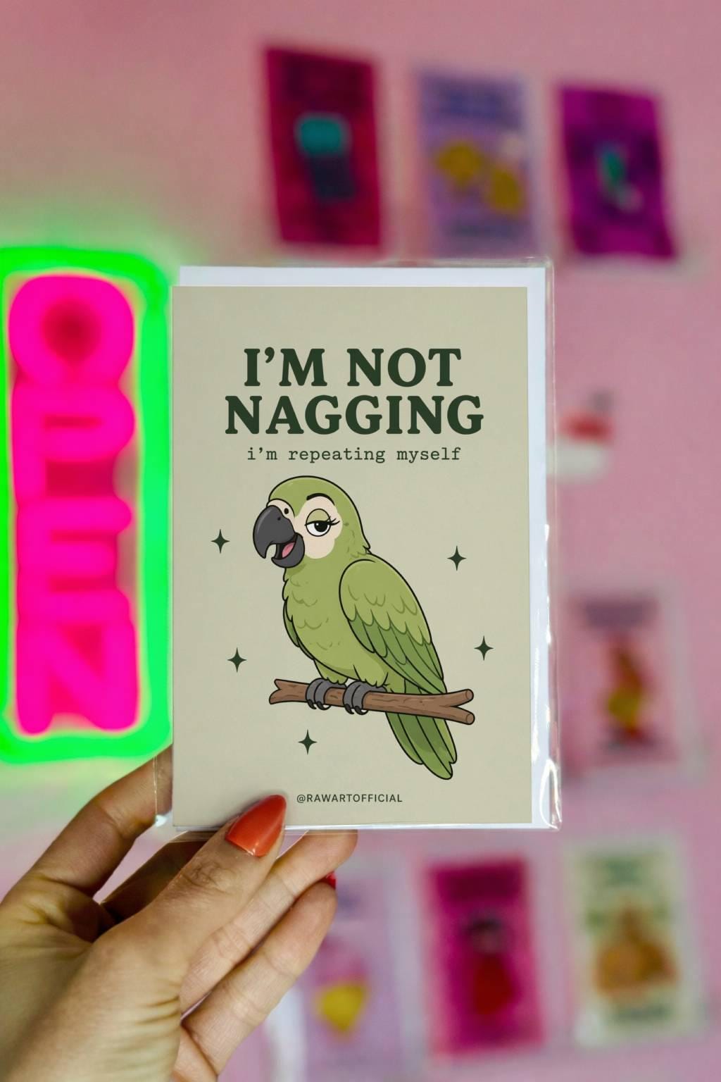 Green parrot illustration with text “I’m not nagging I’m repeating myself” on a neutral background